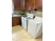 Full kitchen with wood cabinets, tile floor, stove and washer/dryer at 327 Ranch Farm Rd, Raleigh, NC 27603