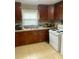 Kitchen with wood cabinets, tile flooring, and a stove and oven at 327 Ranch Farm Rd, Raleigh, NC 27603