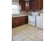 Full kitchen with wood cabinets, stove, and washer/dryer at 327 Ranch Farm Rd, Raleigh, NC 27603