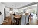 Eat-in kitchen with white cabinets, stainless steel appliances, and hardwood floors at 5356 Cypress Ln, Raleigh, NC 27609