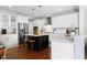 Island kitchen with stainless steel appliances and white cabinets at 5356 Cypress Ln, Raleigh, NC 27609