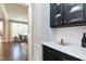 Butlers pantry with dark cabinetry and a quartz countertop at 5356 Cypress Ln, Raleigh, NC 27609