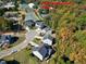 Aerial view of house and surrounding community, showing tennis courts and club house at 5356 Cypress Ln, Raleigh, NC 27609