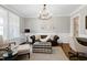 Cozy sitting room featuring a leather sofa and a stylish ottoman at 5356 Cypress Ln, Raleigh, NC 27609