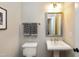 Small bathroom with pedestal sink, toilet, and mirror at 5356 Cypress Ln, Raleigh, NC 27609