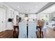 Kitchen features white cabinets, stainless steel appliances, and an island at 5356 Cypress Ln, Raleigh, NC 27609