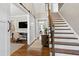 Bright entryway with hardwood floors, staircase, and barn door at 5356 Cypress Ln, Raleigh, NC 27609