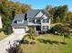 Two-story house with a three-car garage and landscaped yard at 5356 Cypress Ln, Raleigh, NC 27609