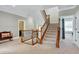Elegant staircase with wrought iron railings and carpeted steps at 5356 Cypress Ln, Raleigh, NC 27609