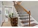 Elegant staircase with wrought iron balusters and wooden steps at 5356 Cypress Ln, Raleigh, NC 27609