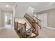 Elegant staircase with wrought iron railings and carpeted steps at 5356 Cypress Ln, Raleigh, NC 27609