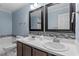Double vanity bathroom with dark brown cabinets and mirrors at 2633 Vega Ct, Raleigh, NC 27614