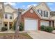 Brick front of townhome with attached garage and landscaping at 2633 Vega Ct, Raleigh, NC 27614