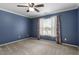 Well-lit bedroom with ceiling fan and patterned curtains at 2633 Vega Ct, Raleigh, NC 27614