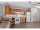 Kitchen with wood cabinets, granite counters and appliances at 2633 Vega Ct, Raleigh, NC 27614