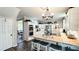 Spacious kitchen boasts white cabinets, stainless steel appliances, and an island with seating at 159 Trantham Trl, Clayton, NC 27527