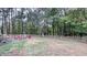 Spacious backyard with wooden fence, fire pit, and seating area at 159 Trantham Trl, Clayton, NC 27527