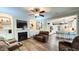 Open living room with fireplace, hardwood floors, and views into the kitchen at 159 Trantham Trl, Clayton, NC 27527