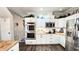 Modern kitchen featuring white cabinets, stainless steel appliances, and butcher block countertops at 159 Trantham Trl, Clayton, NC 27527