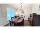 Elegant dining room with a wood table, chandelier, and hardwood floors at 159 Trantham Trl, Clayton, NC 27527