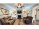 Comfortable living room featuring hardwood floors, a fireplace, and built-in shelving at 159 Trantham Trl, Clayton, NC 27527