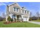 Two-story home with gray siding, stone accents, and a landscaped lawn at 71 Macy Cir, Wendell, NC 27591