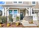 Inviting front porch with stone columns and a dark-colored front door at 71 Macy Cir, Wendell, NC 27591