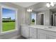 Double vanity bathroom with large mirror and natural light at 71 Macy Cir, Wendell, NC 27591