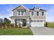 Two story home with stone accents and landscaping at 71 Macy Cir, Wendell, NC 27591