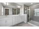 Elegant bathroom with double vanity, large mirror, and a walk-in shower at 71 Macy Cir, Wendell, NC 27591