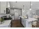 Modern kitchen with island, stainless steel appliances, and hardwood floors at 71 Macy Cir, Wendell, NC 27591