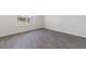 Simple bedroom with gray vinyl plank flooring and a window at 210 Bay Laurel Dr, Sanford, NC 27332