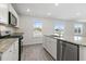 Modern kitchen with white cabinets, granite countertops, and stainless steel appliances at 210 Bay Laurel Dr, Sanford, NC 27332