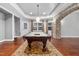 Basement game room with pool table, stone wall, and hardwood floors at 3007 Olde Weatherstone Way, Cary, NC 27513