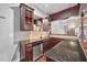 Basement bar with granite countertops and wood cabinets at 3007 Olde Weatherstone Way, Cary, NC 27513
