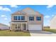 Two-story home with stone accents and a two-car garage at 317 Leven Dr, Gibsonville, NC 27249