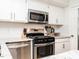 Stainless steel appliances and white cabinets in this kitchen at 3736 Jamestown Cir, Raleigh, NC 27609