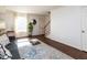 Living room with hardwood floors, stairs, and a cozy seating area at 3736 Jamestown Cir, Raleigh, NC 27609