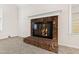 Brick fireplace with glass doors in living room at 8404 Running Cedar Trl, Raleigh, NC 27615