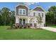 Two-story home with gray siding, stone accents, and a landscaped lawn at 87 Macy Cir, Wendell, NC 27591