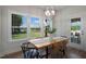 Charming dining area with a wooden table, natural light, and access to a patio at 87 Macy Cir, Wendell, NC 27591