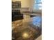 Kitchen with granite countertops and black appliances at 1111 Nottingham Cir, Cary, NC 27511