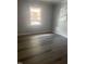 Bedroom with gray vinyl plank flooring and window at 1111 Nottingham Cir, Cary, NC 27511