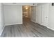 Living room with gray vinyl plank flooring and access to other rooms at 1111 Nottingham Cir, Cary, NC 27511