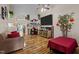 Living room with hardwood floors, fireplace, and large TV at 2125 Star Sapphire Dr, Raleigh, NC 27610