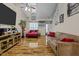 Living room with hardwood floors, fireplace, and large TV at 2125 Star Sapphire Dr, Raleigh, NC 27610