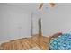 Bedroom with double doors to closet and wood flooring at 2125 Star Sapphire Dr, Raleigh, NC 27610