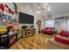 Living room with hardwood floors, fireplace, and large TV at 2125 Star Sapphire Dr, Raleigh, NC 27610