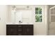 Double vanity bathroom with updated fixtures and a large mirror at 152 Hanover Dr, Sanford, NC 27330