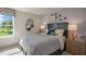 Bedroom with wood nightstand and large window at 6429 Alfalfa Ln, Wake Forest, NC 27587